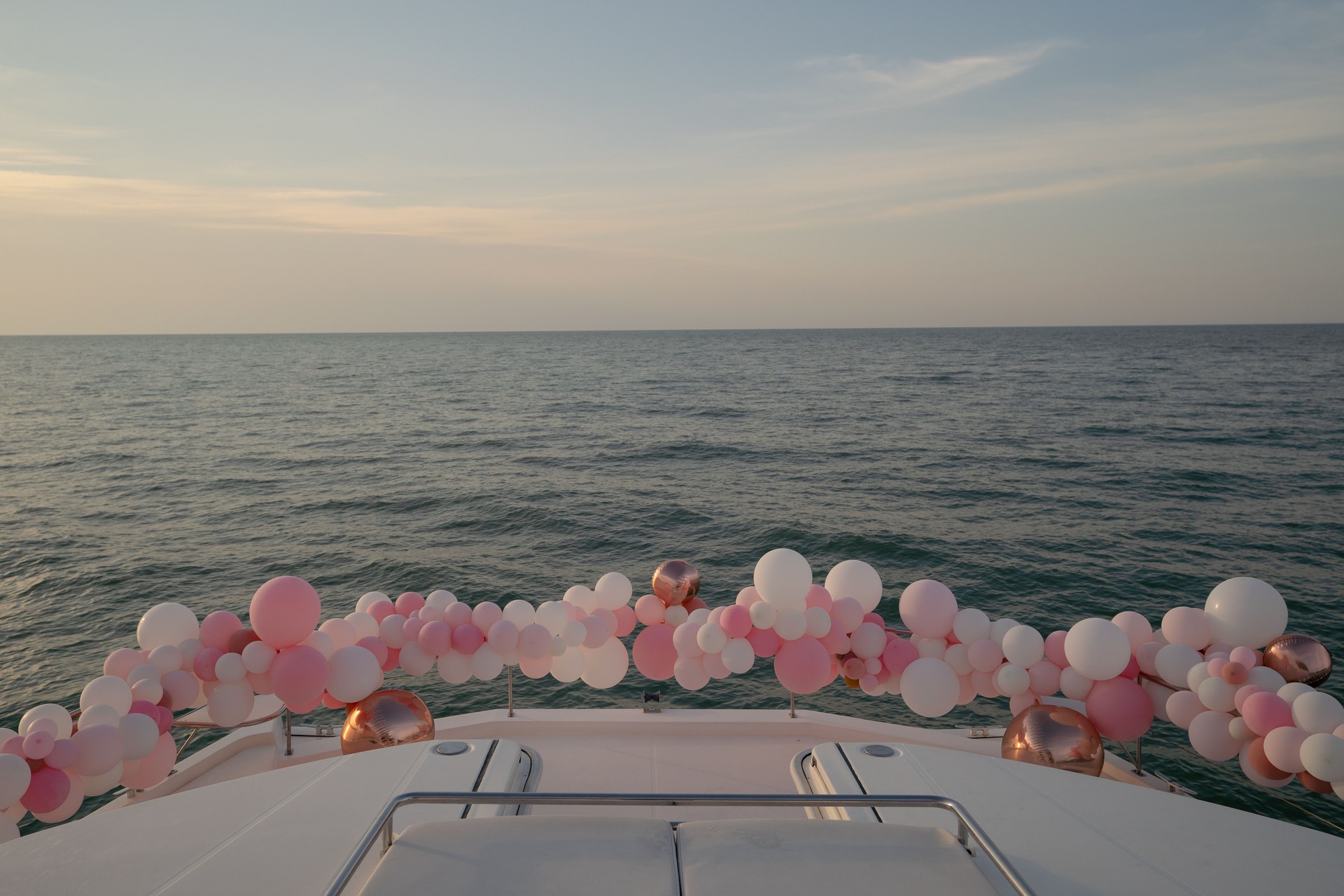 Party balloon decorations adorning a private yacht. Birthday celebration concept.