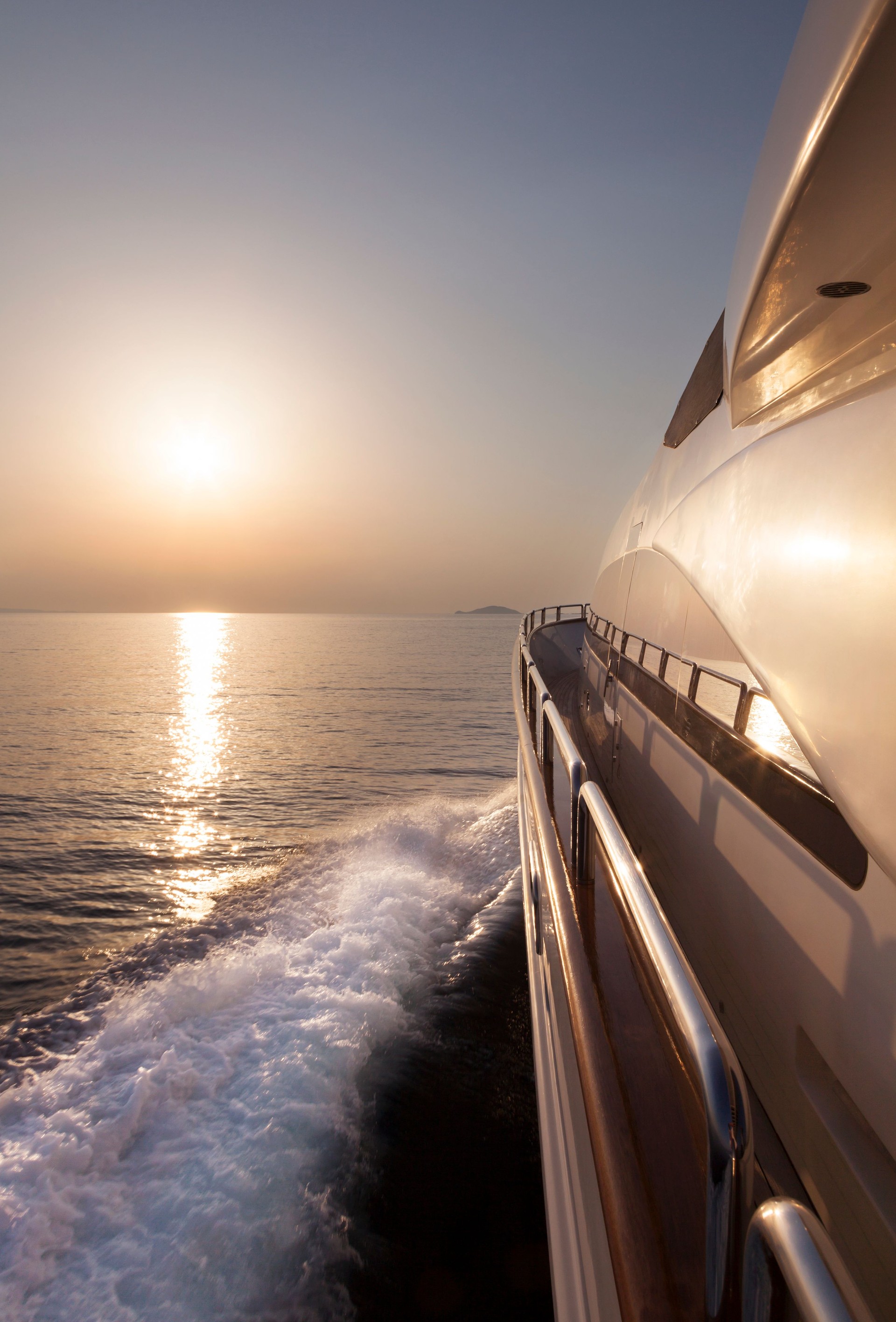 Luxury motor yacht sailing at sunset
